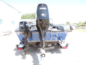 A boat with two outboards attached to it.