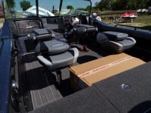 A boat with many seats and boxes on the back.