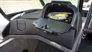 A car dashboard with the lid open and a banana in it.