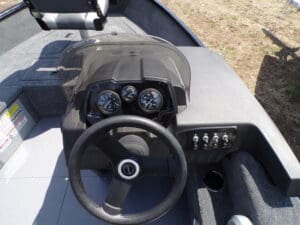 A boat with a steering wheel and dashboard.