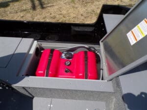 A red suitcase is in the open case.
