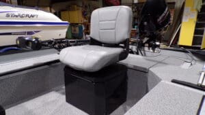 Gray cushioned fishing boat seat on pedestal