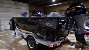Black fishing boat with outboard motor