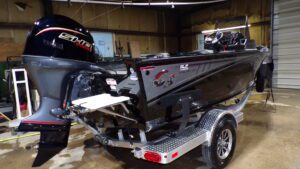 Black bass boat with outboard motor on trailer