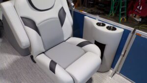 Gray and white boat seat with cup holders
