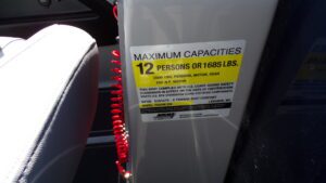 Boat capacity sticker reading 12 persons, 1685 lbs
