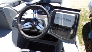 Boat helm with steering wheel and Garmin display