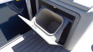 Open built-in trash bin on boat deck