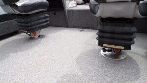 Two pedestal boat seats on carpeted deck