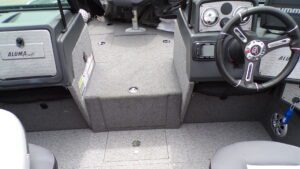 Carpeted aluminum boat cockpit with steering wheel
