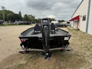 Black fishing boat with outboard motor displayed.