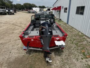 Red fishing boat with outboard motor visible.