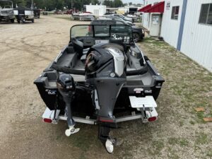 Fishing boat with dual outboard motors visible.